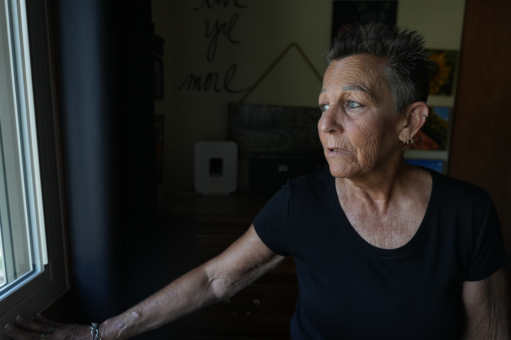 Deb Robertson looks towards trees outside her home near a park where her ashes will be buried next to a tree, in Lombard, Ill., on Tuesday, Sept. 8, 2026. (AP Photo/Luis Andres Henao)