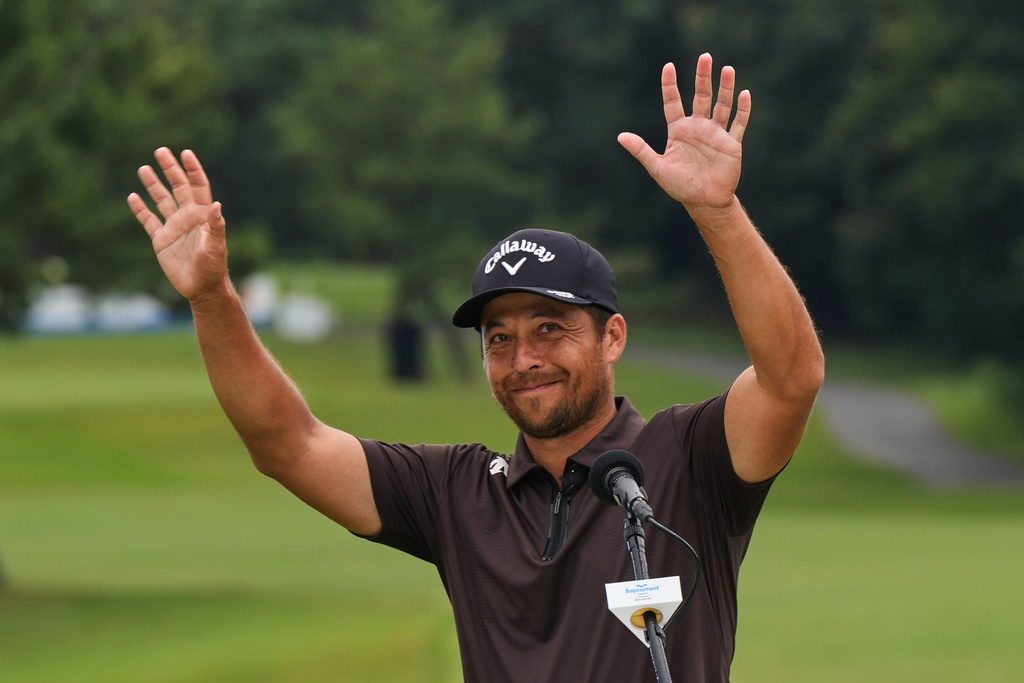 Xander Schauﬀele, of the U.S., waves towards audience members after making a winner's speech as he won the Baycurrent Classic golf tournament at the Yokohama Country Club in Yokohama, near Tokyo, Sunday, Oct. 12, 2025. (AP Photo/Hiro Komae)