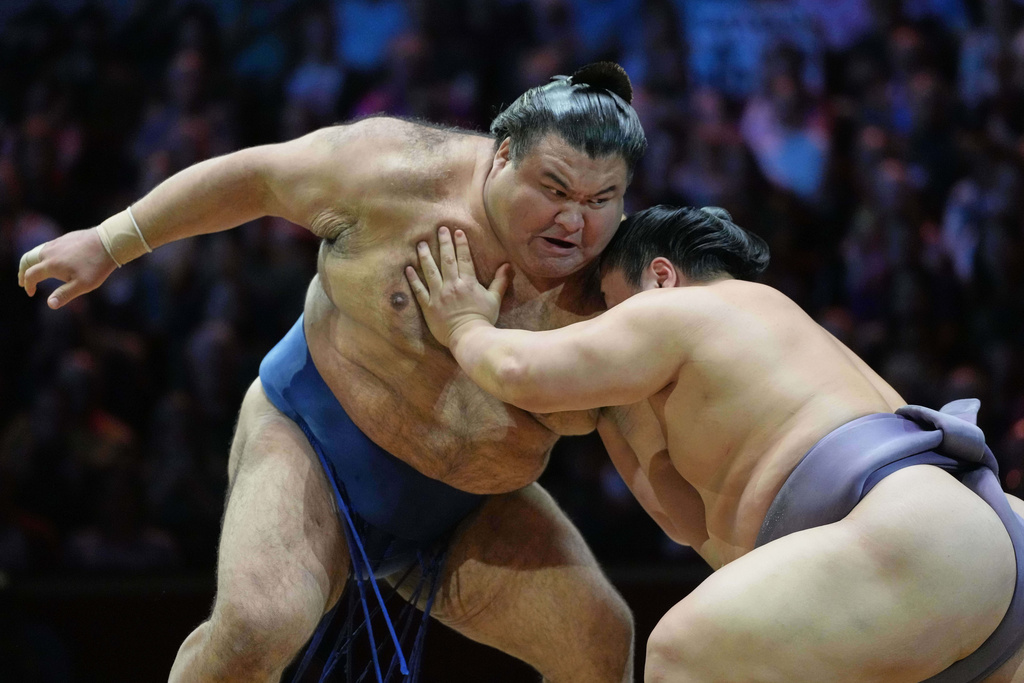 Sumo rikishi Takayasu, left, and Tobizaru during their Grand Sumo Tournament bout on the dohyo, the sacred sumo wrestling ring, at the Royal Albert Hall in London, Sunday, Oct. 19, 2025.(AP Photo/Frank Augstein)