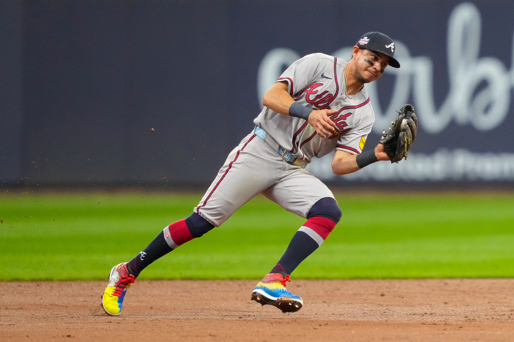 Atlanta Braves shortstop Mauricio Dubón forces out Milwaukee Brewers' William Contreras at second base as Brewers' Jackson Chourio scores and Andrew Vaughn makes it safely to first base during the third inning of a baseball game Friday, Aug. 21, 2026, in Milwaukee. (AP Photo/Kayla Wolf)