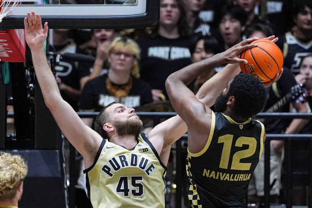 Purdue center Oscar Cluff (45) blocks the shot of Oakland forward Tuburu Naivalurua (12) during the second half of an NCAA college basketball game in West Lafayette, Ind., Friday, Nov. 7, 2025. (AP Photo/Michael Conroy)