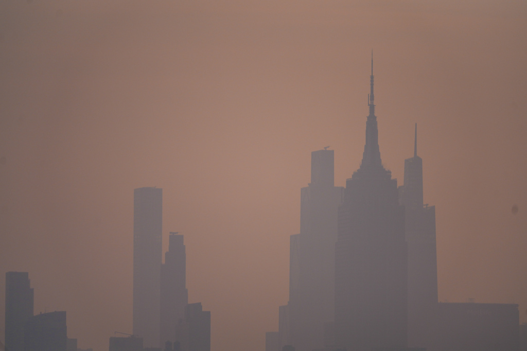 The New York City skyline is seen through a cover of wildfire smoke, in Jersey City, N.J., Friday, July 17, 2026. (AP Photo/Ryan Murphy)