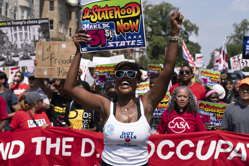 Demonstrators protest against President Donald Trump's deployment of federal law enforcement and National Guard troops in Washington during a march on Saturday, Sept. 6, 2025. (AP Photo/Jose Luis Magana)