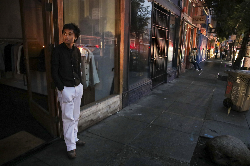 Ryan Sicat, store manager of Industry of All Nations, stands outside the store after a major power outage in San Francisco, Saturday, Dec. 20, 2025. (Yalonda M. James/San Francisco Chronicle via AP)