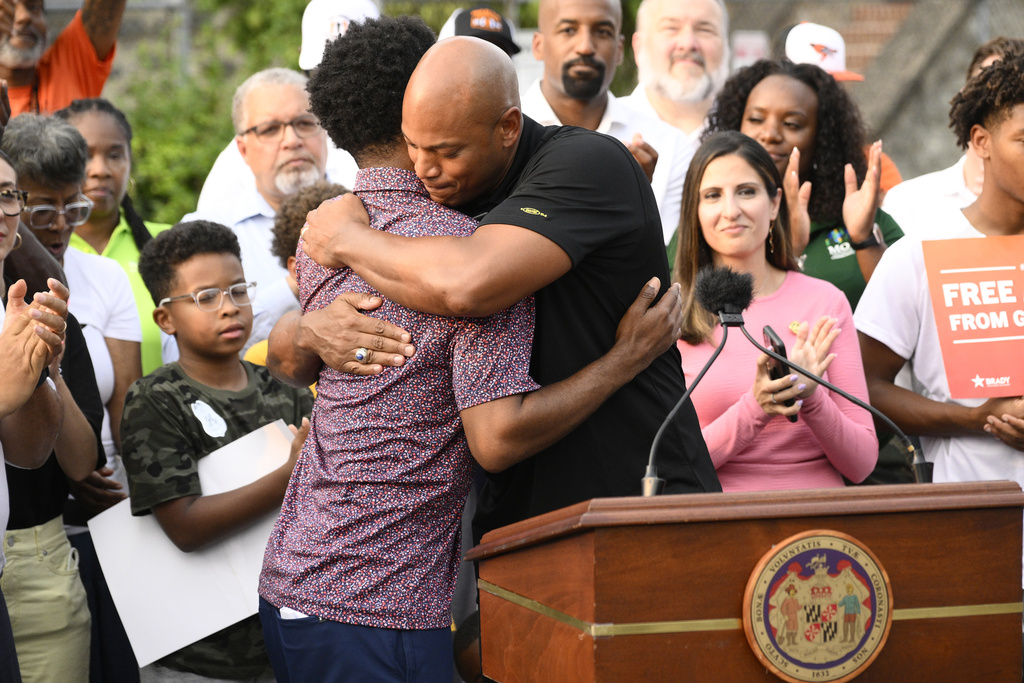 Maryland Gov. Wes Moore, right, hugs Baltimore mayor Brandon Scott, left, at a news conference, Friday, Sept. 5, 2025, in Baltimore. (AP Photo/Nick Wass)