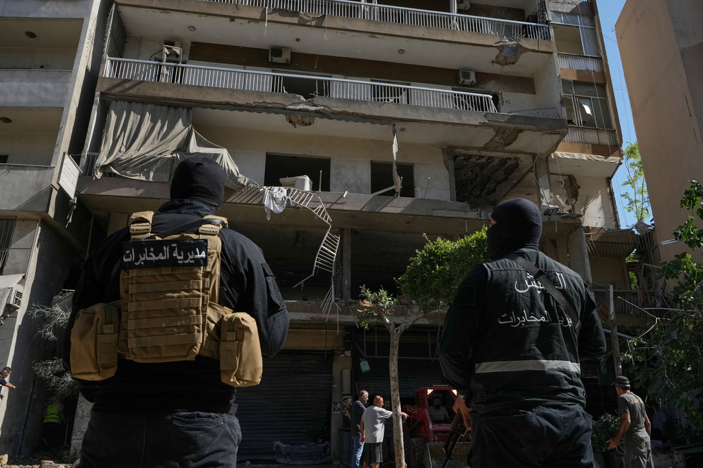 Members of the Lebanese Army Intelligence stand guard in front of an apartment that was struck in an Israeli airstrike in Dahiyeh, Beirut's southern suburbs, Lebanon, Sunday, June 14, 2026. (AP Photo/Bilal Hussein)