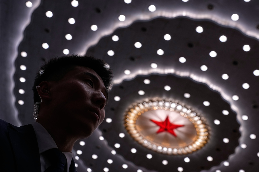 A soldier dressed as usher stands watch ahead of a plenary session of the National People's Congress (NPC) at the Great Hall of the People, in Beijing, Monday, March 9, 2026. (AP Photo/Andy Wong)