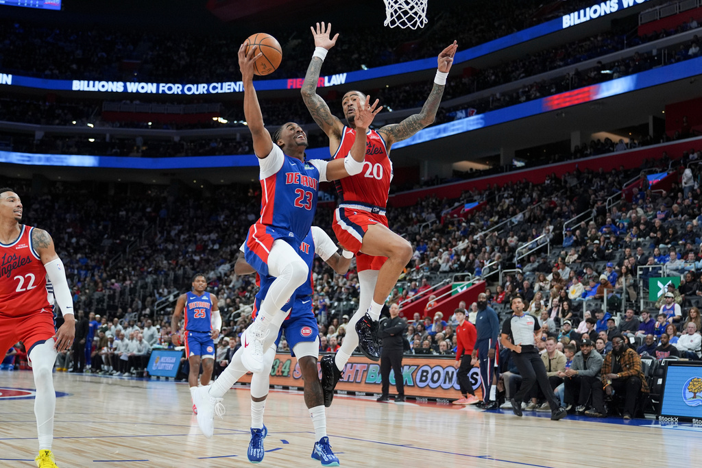 Detroit Pistons guard Jaden Ivey (23) shoots against Los Angeles Clippers forward John Collins (20) during the first half of an NBA basketball game, Saturday, Jan. 10, 2026, in Detroit. (AP Photo/Ryan Sun)