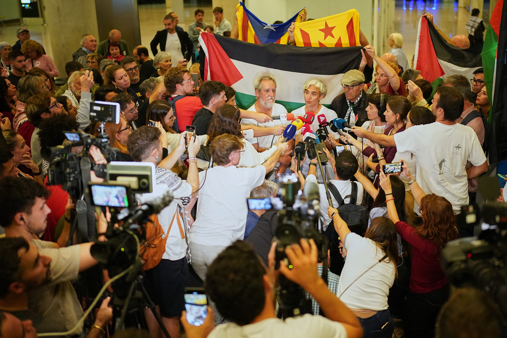 Former Barcelona mayor Ada Colau speaks with media as she arrives at the airport in Barcelona, Spain, Sunday, Oct. 5, 2025, after being arrested on the Global Sumud Flotilla and subsequently released by the Israeli authorities. (AP Photo/Joan Mateu Parra)