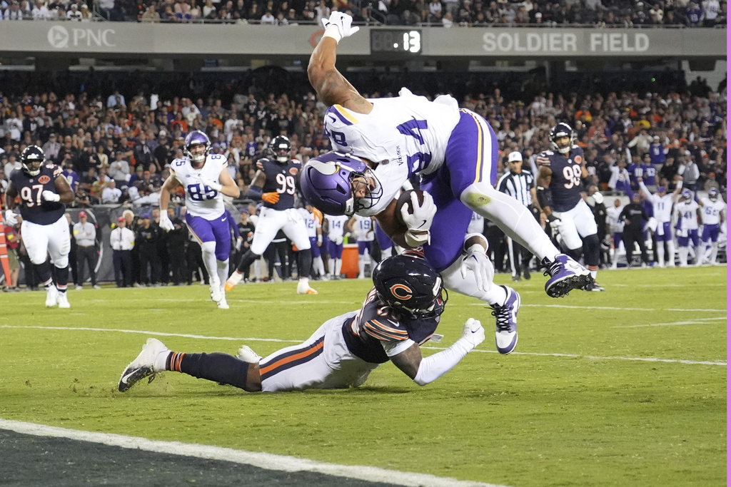 Minnesota Vikings tight end Josh Oliver, right, is stopped short of the end zone by Chicago Bears defensive back Jonathan Owens during the second half of an NFL football game Monday, Sept. 8, 2025, in Chicago. (AP Photo/Nam Y. Huh)