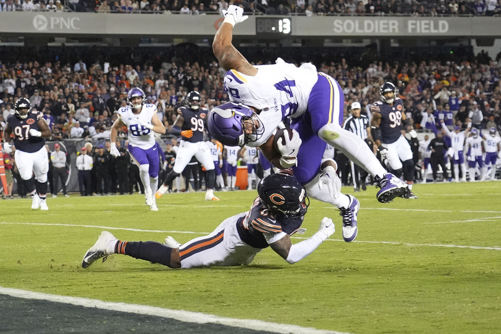 Minnesota Vikings tight end Josh Oliver, right, is stopped short of the end zone by Chicago Bears defensive back Jonathan Owens during the second half of an NFL football game Monday, Sept. 8, 2025, in Chicago. (AP Photo/Nam Y. Huh)