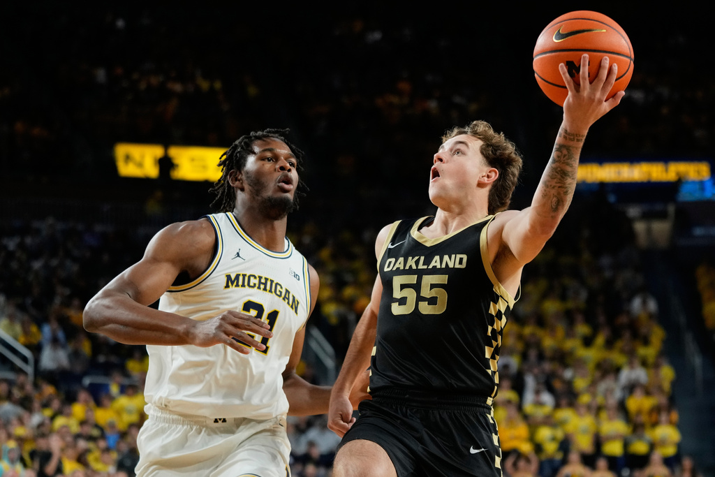 Oakland guard Brody Robinson (55) shoots against Michigan forward Morez Johnson Jr. during the first half of an NCAA college basketball game, Monday, Nov. 3, 2025, in Ann Arbor, Mich. (AP Photo/Ryan Sun)