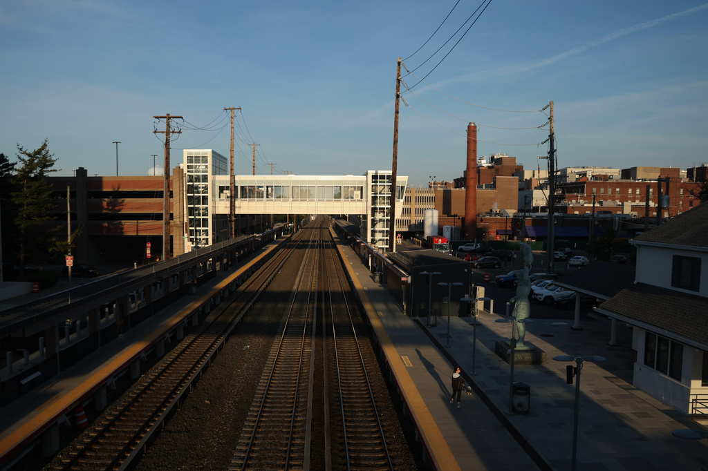 A pedestrian walks along an empty track at Mineola train station as Long Island Rail Road workers strike, Monday, May 18, 2026, in Mineola, N.Y. (AP Photo/Heather Khalifa)