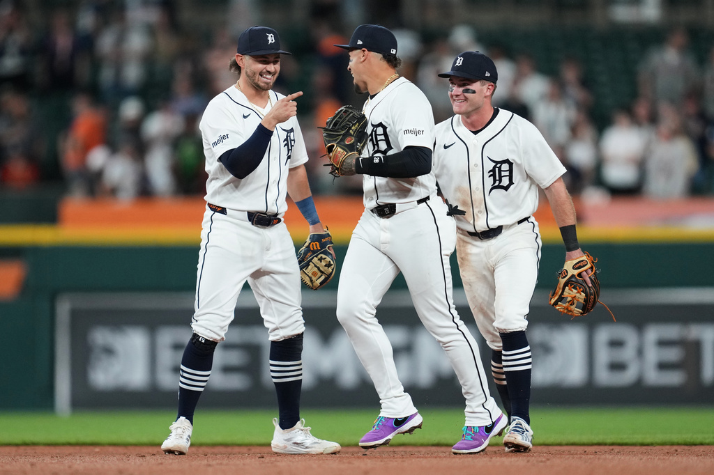 Detroit Tigers' Zach McKinstry, from left, Javier Báez and Kevin McGonigle celebrate after the final out in the ninth inning of a baseball game against the Kansas City Royals Tuesday, April 14, 2026, in Detroit. (AP Photo/Paul Sancya)