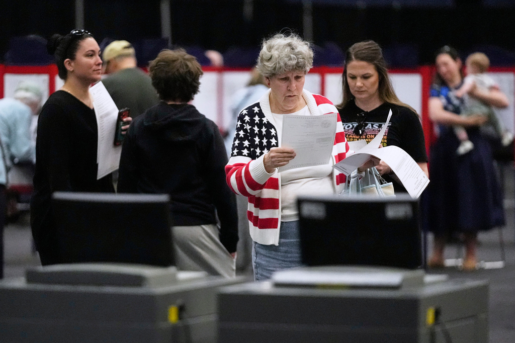 Mary Saunders looks over her choices one last time before casting her ballots in the Maine Primary, Tuesday, June 9, 2026, in Augusta, Maine. (AP Photo/Robert F. Bukaty)
