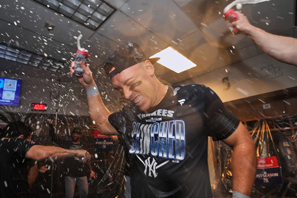 New York Yankees' Aaron Judge, center, celebrates with teammates after they clinched the playoffs in a baseball game against the Minnesota Twins, Monday, Sept. 14, 2026, in Minneapolis. (AP Photo/Abbie Parr)