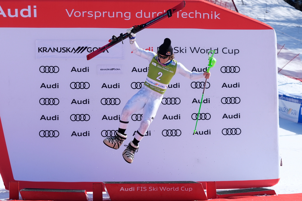 Brazil's Lucas Pinheiro Braathen celebrates on the podium after taking third place in an alpine ski, men's World Cup slalom, in Kranjska Gora, Slovenia, Sunday, March 8, 2026. (AP Photo/Giovanni Auletta)