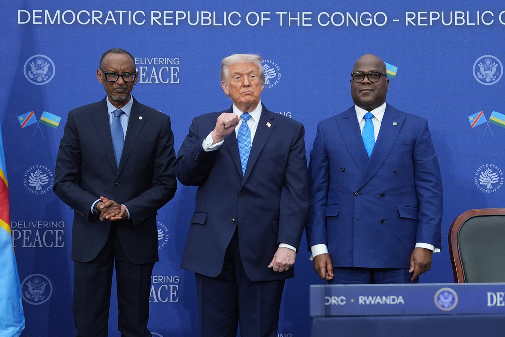 President Donald Trump stands with Rwanda's President Paul Kagame and Democratic Republic of Congo President Felix-Antoine Tshisekedi at the U.S. Institute of Peace, Thursday, Dec. 4, 2025, in Washington. (AP Photo/Evan Vucci)