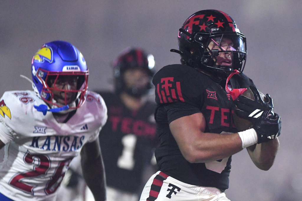 Texas Tech running back Cameron Dickey (8) runs into the end zone for a touchdown during the fourth quarter of an NCAA college football game, Saturday, Oct. 11, 2025, in Lubbock, Texas. (AP Photo/Annie Rice)