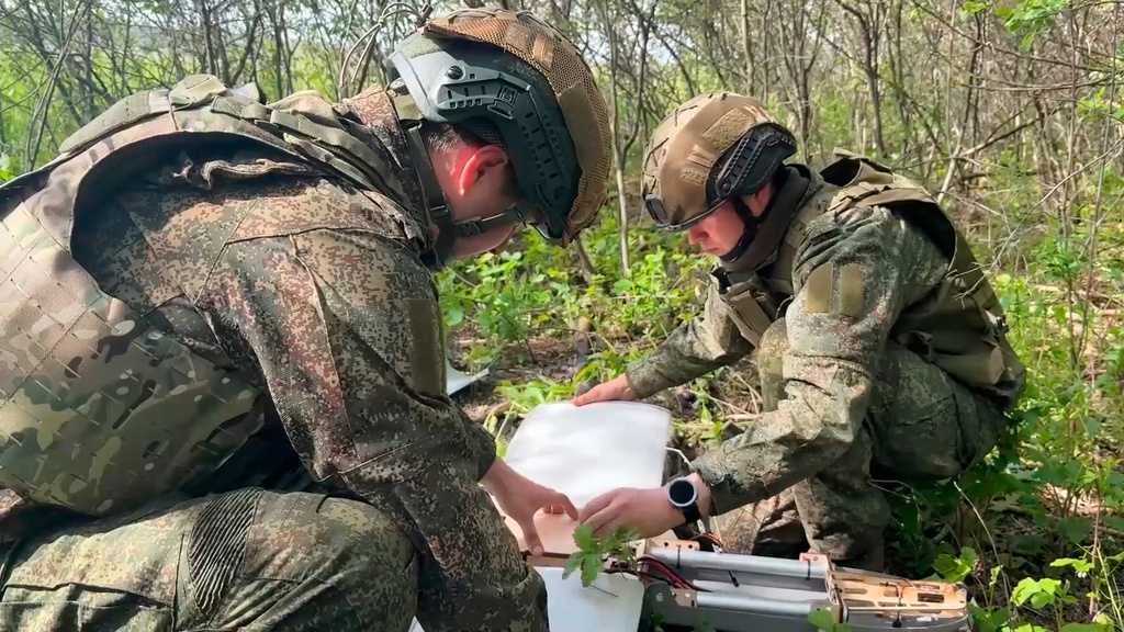 In this image made from video provided by Russian Defense Ministry Press Service on Wednesday, May 20, 2026, Russian servicemen prepare to launch an interceptor drone for an action in an undisclosed location in Ukraine. (Russian Defense Ministry Press Service via AP)