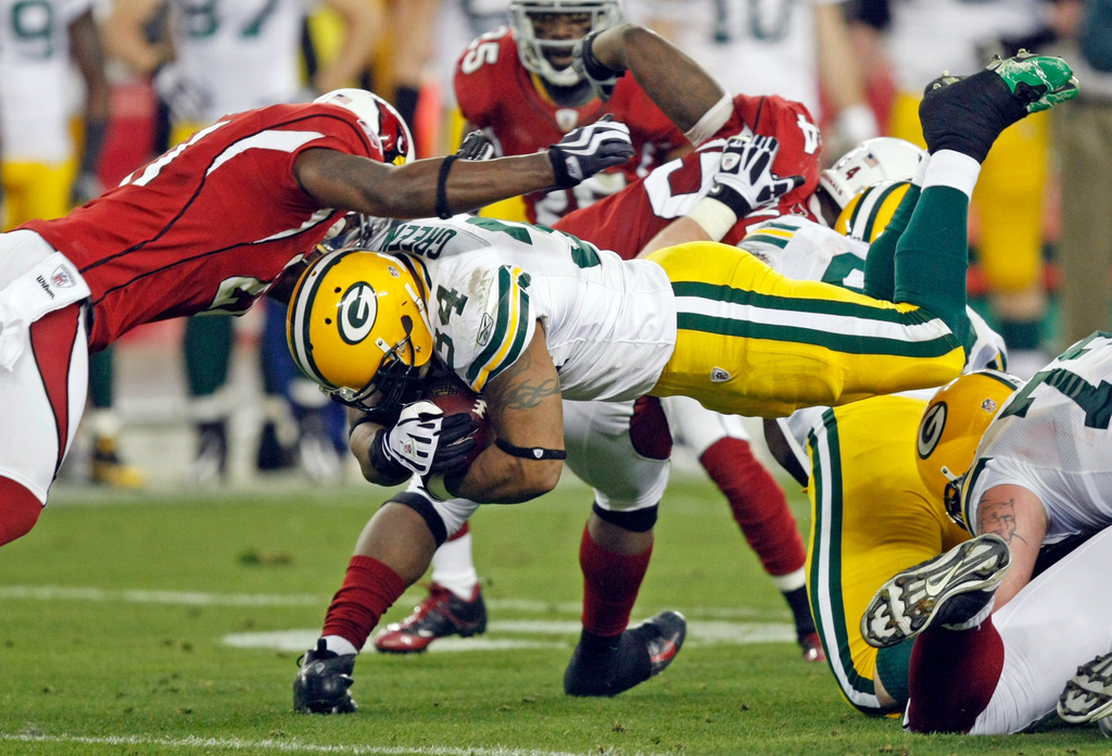 FILE - Green Bay Packers' Ahman Green (34) dives for a first down in front of Arizona Cardinals' Antrel Rolle (21) during the second half of an NFL wild-card playoff football game, Jan. 10, 2010, in Glendale, Ariz. (AP Photo/Matt York, File)