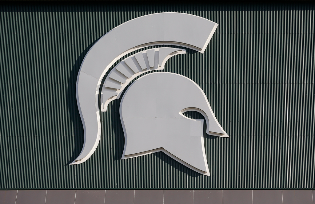 FILE - Michigan State's logo hangs on Spartan Stadium before the start of an NCAA college football game between Michigan State and Tulsa, Aug. 30, 2019, in East Lansing, Mich. (AP Photo/Al Goldis, File)