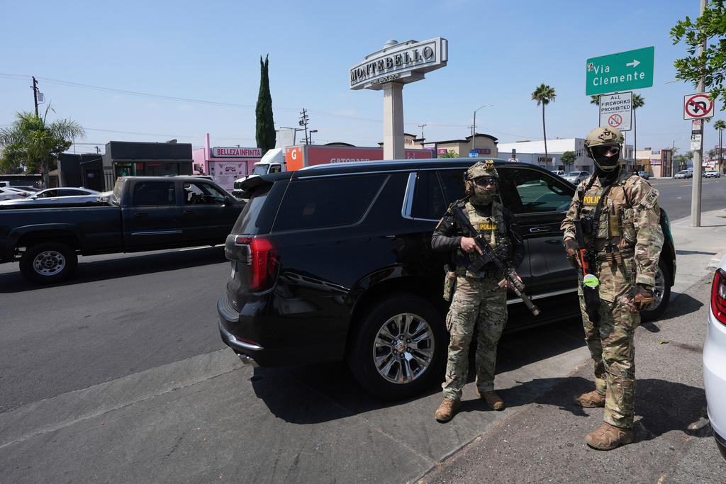 FILE - Immigration agents conduct an operation at a car wash, Aug. 15, 2025, in Montebello, Calif. (AP Photo/Gregory Bull, File)