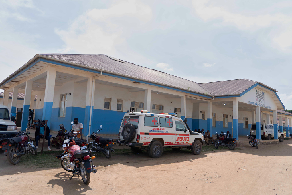 People wait near an ambulance at a hospital in Bunia, Congo, Sunday, May 17, 2026. (AP Photo/ Dirole Lotsima Dieudonne)