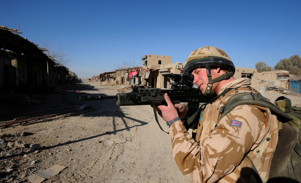 FILE - In this image made available in London, Thursday Feb. 28, 2008, Britain's Prince Harry patrols through the deserted town of Garmisir, Afghanistan, close to Forward Operating Base Delhi, on Wednesday Jan. 2, 2008. (AP Photo/John Stillwell, Pool/File)