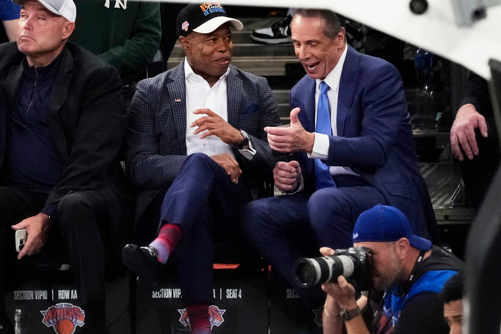 Independent candidate former New York Gov. Andrew Cuomo, right, talks to New York City Mayor Eric Adams during the second half of an NBA basketball game between the New York Knicks and the Cleveland Cavaliers Wednesday, Oct. 22, 2025, at Madison Square Garden in New York. (AP Photo/Frank Franklin II)