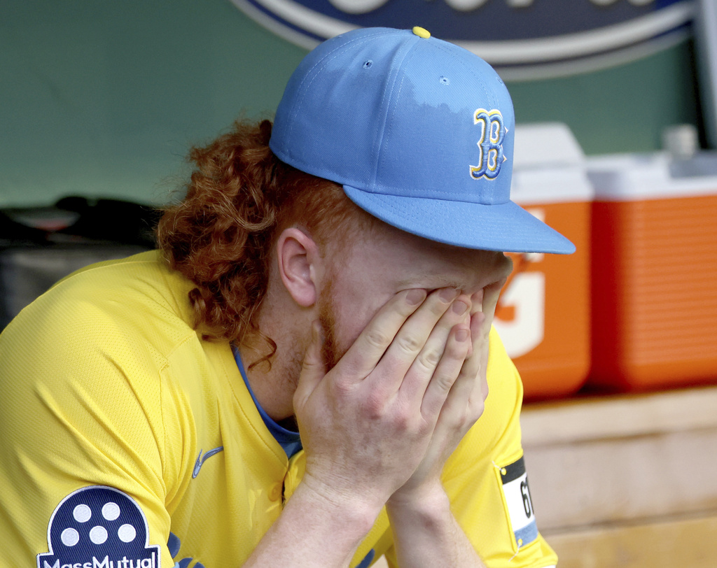 Boston Red Sox pitcher Dustin May reacts in the dugout after being pulled during the sixth inning of a baseball game against the Pittsburgh Pirates, Saturday, Aug. 30, 2025, in Boston. (AP Photo/Mark Stockwell)
