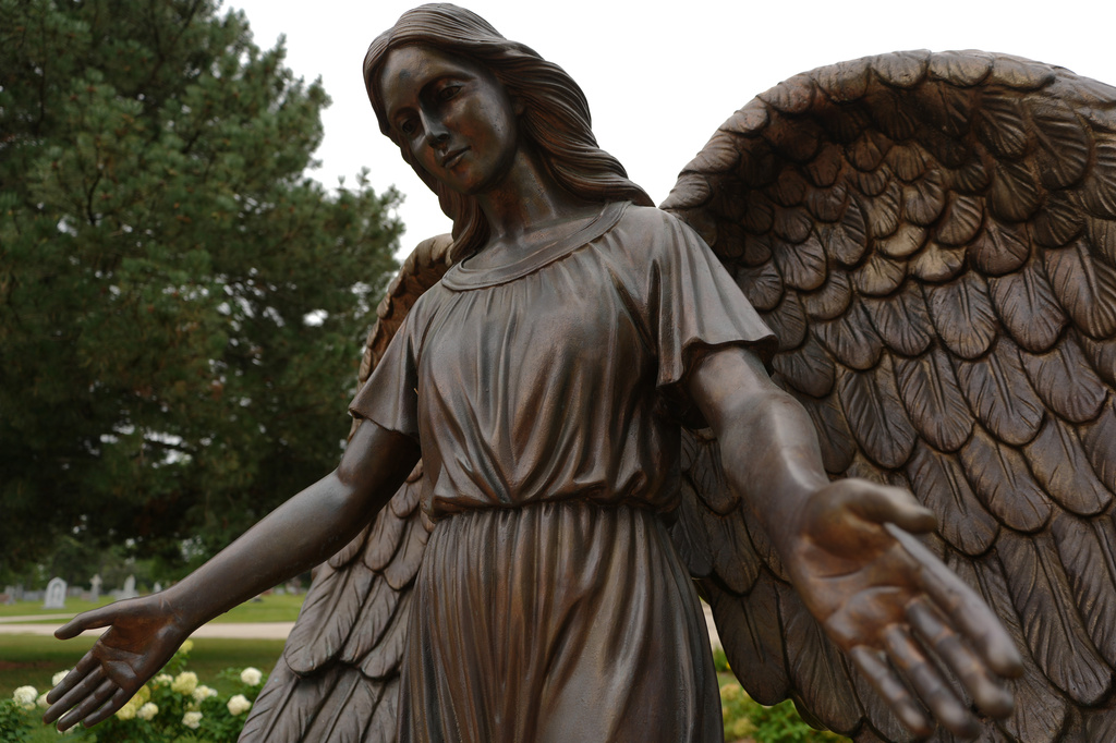 A sculpture of an angel stands at a memorial for survivors and lives lost to suicide dedicated by the Archdiocese of Chicago at Queen of Heaven Catholic Cemetery in Hillside, Ill., on Wednesday, Sept. 9, 2026. (AP Photo/Luis Andres Henao)