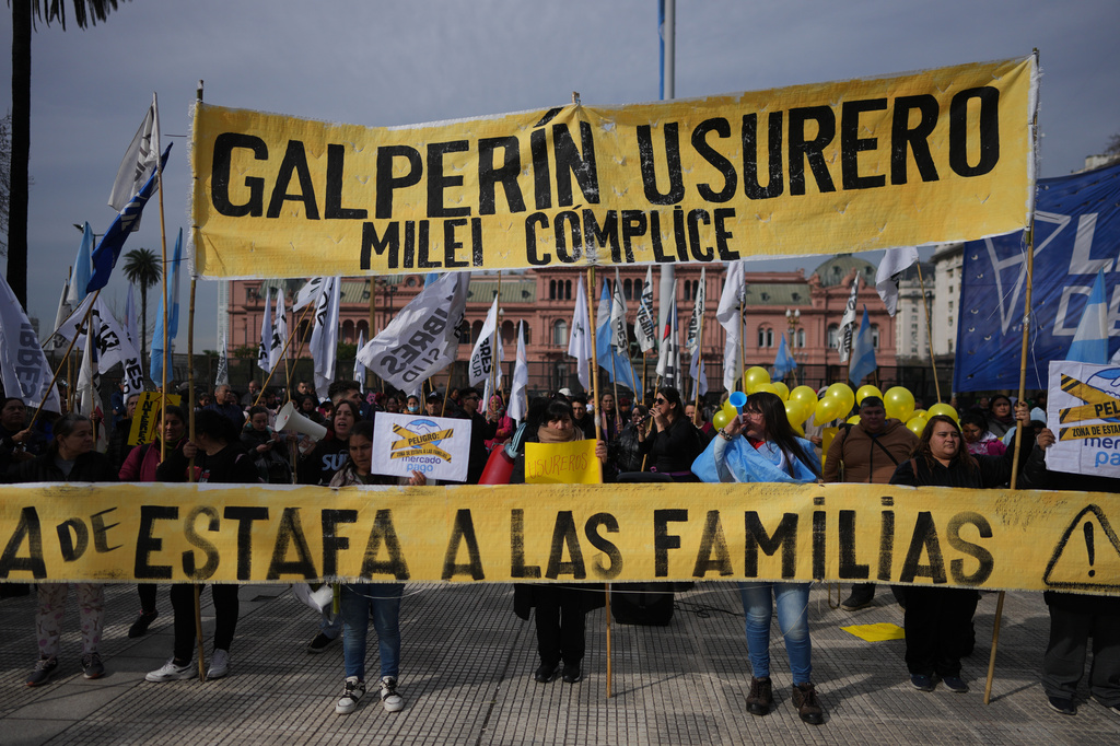 Demonstrators hold a banner with a message that reads in Spanish: "Galperin loan shark, Milei an accomplice" outside the Economy Ministry to demand government action over a household debt crisis in Buenos Aires, Argentina, Thursday, Aug. 20, 2026. (AP Photo/Victor R. Caivano, File)