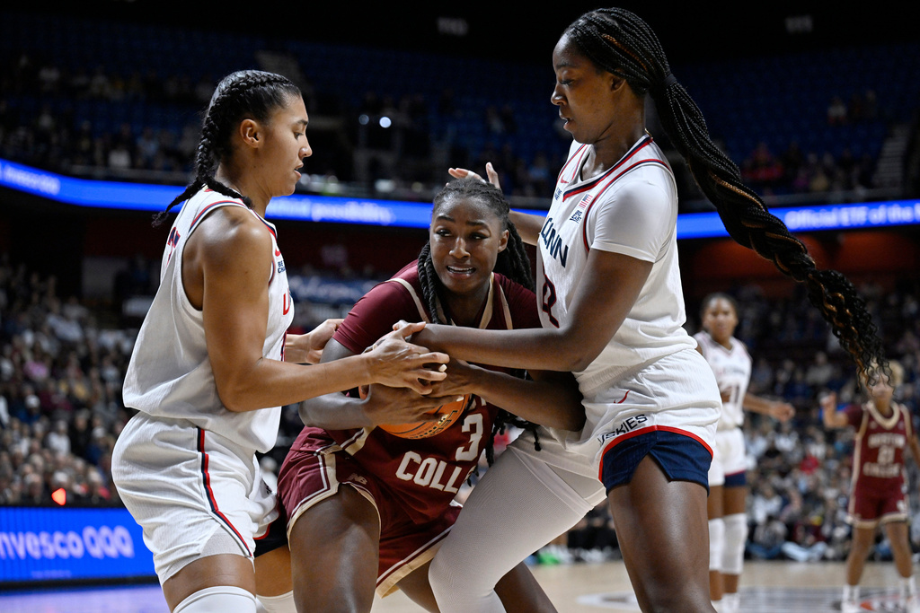 UConn guard Azzi Fudd, left, and UConn forward Serah Williams, right, pressure Boston College guard Ava McGee, center, in the first half of an exhibition NCAA college basketball game, Monday, Oct. 13, 2025, in Uncasville, Conn. (AP Photo/Jessica Hill)
