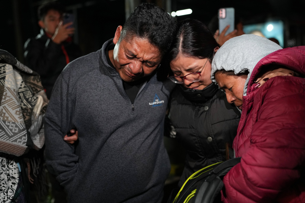 Relatives cry after receiving the remains of Maria Florinda Ríos Perez who was killed in Indiana, at La Aurora International Airport in Guatemala City, Sunday, Nov. 23, 2025. (AP Photo/Moises Castillo)