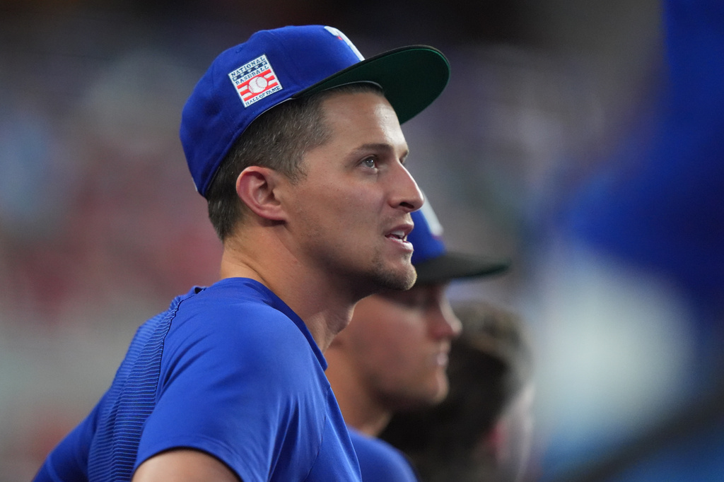 Texas Rangers' Corey Seager looks on from the dugout during a baseball game against the Seattle Mariners, Sunday, July 26, 2026, in Arlington, Texas. (AP Photo/LM Otero)