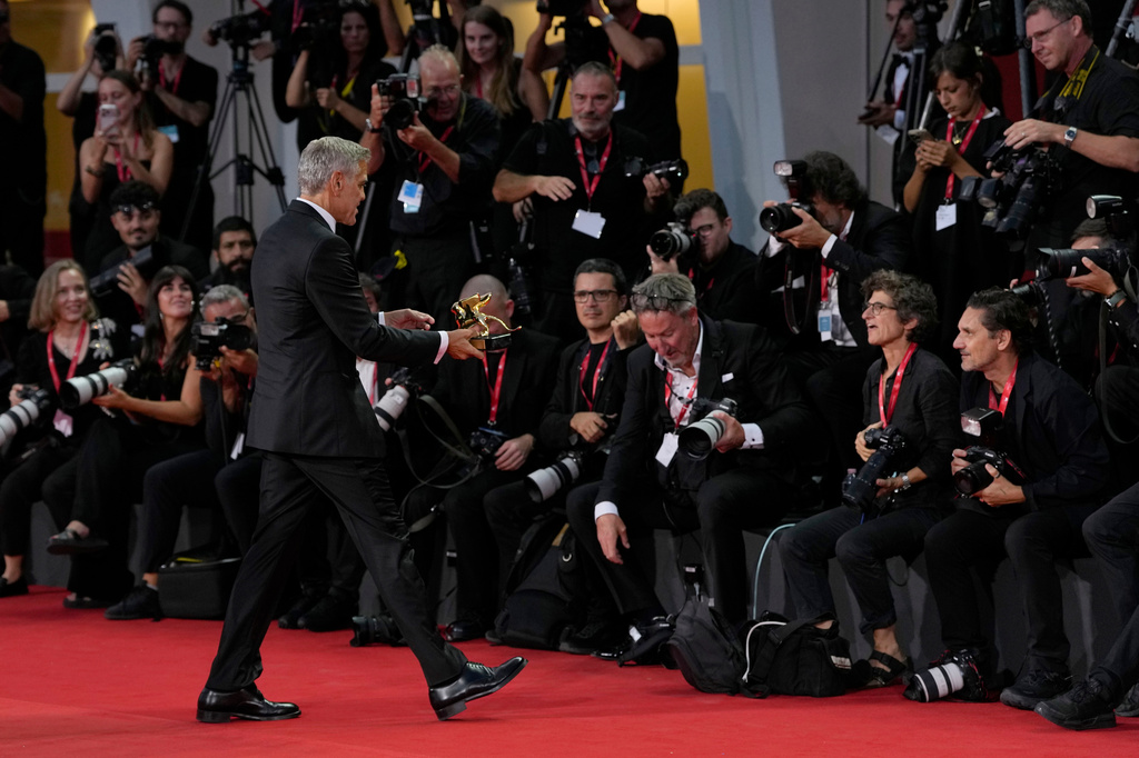 George Clooney poses for photographers with the golden lion for lifetime achievement during the 83rd edition of the Venice Film Festival in Venice, Italy, on Wednesday, Sept. 2, 2026. (Photo by Alessandra Tarantino/Invision/AP)