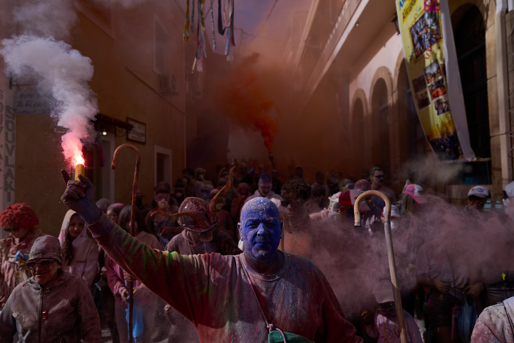 Revelers take part in the annual flour war marking the end of the Carnival season on Clean Monday in Galaxidi, about 200 kilometers (120 miles) west of Athens, Monday Feb. 23, 2026, starting the 40-day Christian Lent fast leading to Easter. (AP Photo/Petros Giannakouris)