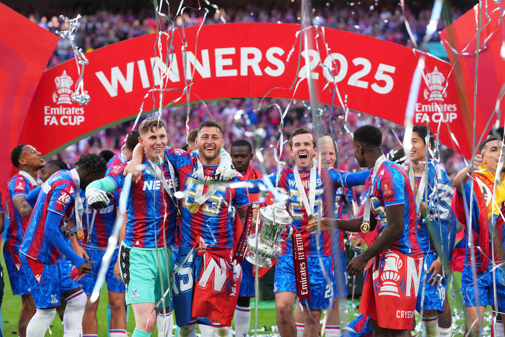 FILE - Crystal Palace players celebrate with the trophy after winning the English FA Cup final soccer match between Crystal Palace and Manchester City at Wembley stadium in London, May 17, 2025. (AP Photo/Kirsty Wigglesworth, File)