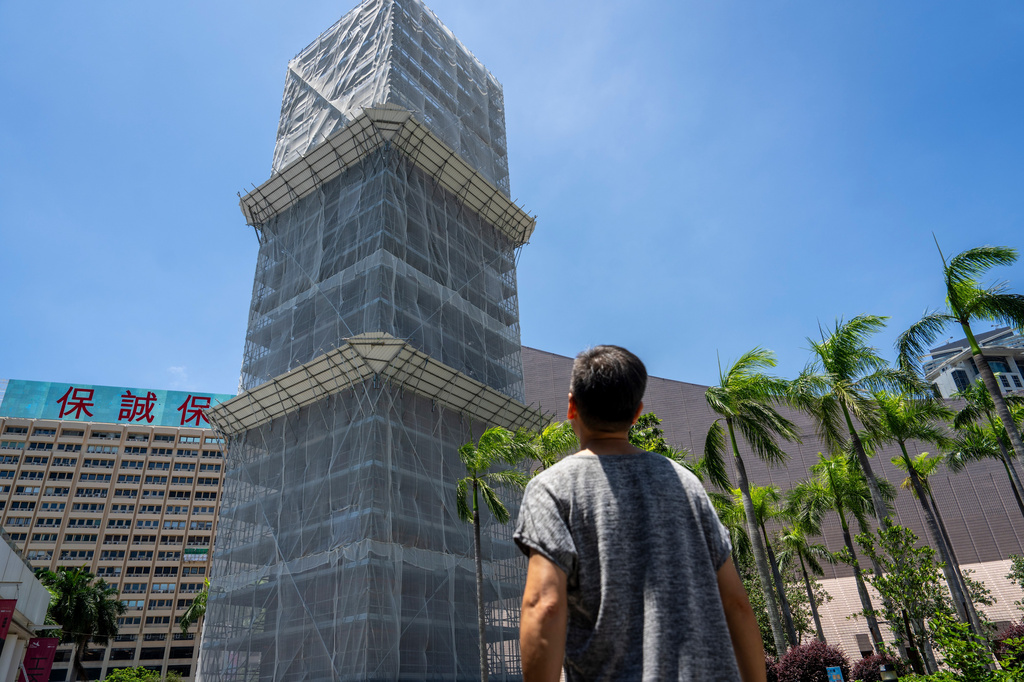 Tang Ngok-kwan visits the clock tower in Tsim Sha Tsui, an area where he used to have long runs with fellow activists to commemorate the Tiananmen crackdown in Hong Kong, Saturday, July 11, 2026. (AP Photo/Chan Long Hei)