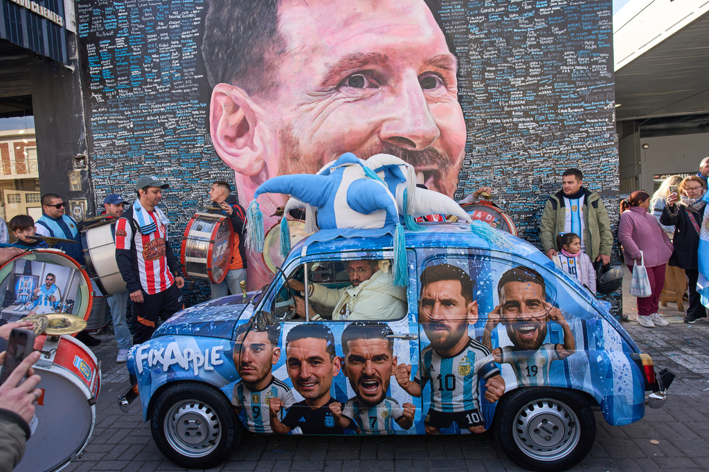 FILE - People sing happy birthday to Lionel Messi at a street mural of him in Buenos Aires, Argentina, June 24, 2026. (AP Photo/Rodrigo Abd, File)