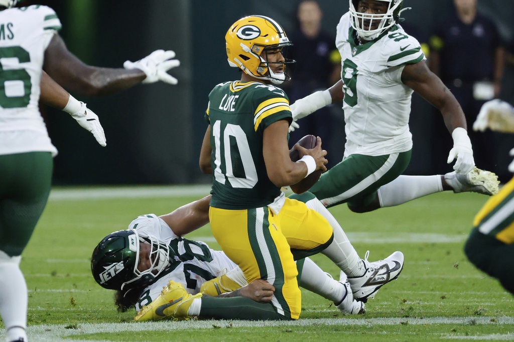 New York Jets' Jay Tufele sacks Green Bay Packers' Jordan Love during the first half of a preseason NFL football game Saturday, Aug. 9, 2025, in Green Bay, Wis. (AP Photo/Mike Roemer)