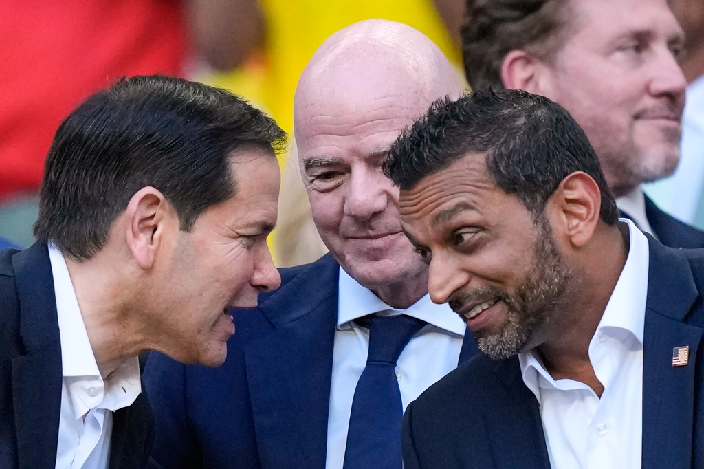 United States Secretary of State, Marco Rubio, left, talks to the Director of the FBI, Kash Patel, right, as FIFA President Gianni Infantino, centre, watches ahead of the World Cup Group K soccer match between Colombia and Portugal in Miami Gardens, Fla., Saturday, June 27, 2026. (AP Photo/Rebecca Blackwell)