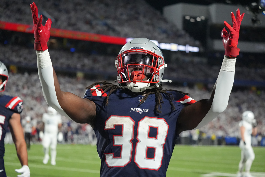 New England Patriots running back Rhamondre Stevenson (38) celebrates his touchdown against the Buffalo Bills during the second half of an NFL football game, Sunday, Sept. 5, 2025, in Orchard Park, N.Y. (AP Photo/Gene J. Puskar)