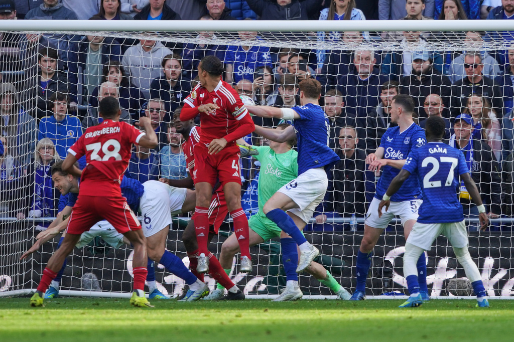 Liverpool's Virgil van Dijk (4) scores his side's 2nd goal during the English Premier League soccer match between Everton and Liverpool in Liverpool, England, Sunday, April 19, 2026. (AP Photo/Ian Hodgson)