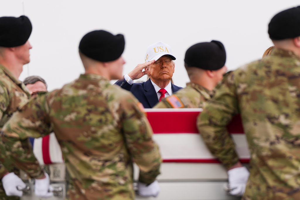 President Donald Trump salutes as an Army carry team moves a flag-draped transfer case with the remains of Sgt. Declan Coady, 20, of West Des Moines, Iowa, who was killed in a drone strike at a command center in Kuwait after the U.S. and Israel launched its military campaign against Iran, during a casualty return, Saturday, March 7, 2026, at Dover Air Force Base, Del. (AP Photo/Julia Demaree Nikhinson)