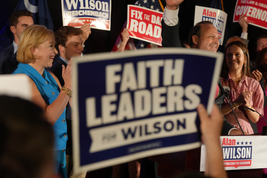 South Carolina Attorney General Alan Wilson, second right, celebrates with his wife Jennifer, children and supporters at his GOP gubernatorial runoff Election Night victory party in Columbia, S.C., Tuesday, June 23, 2026. (AP Photo/Meg Kinnard)