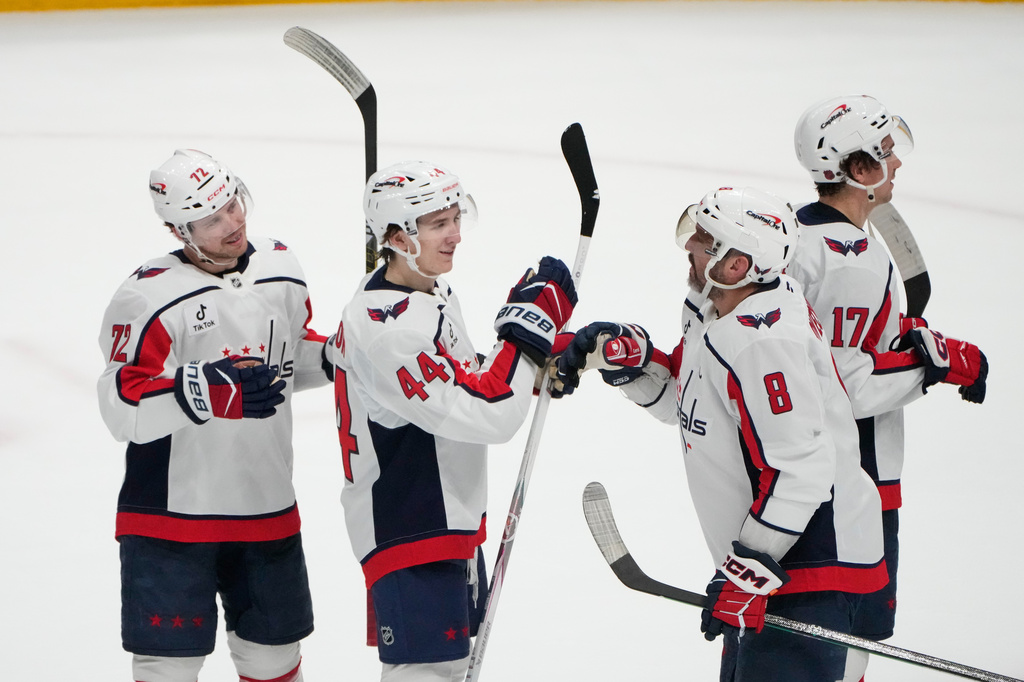 Washington Capitals' Alex Ovechkin (8) celebrates with teammates Anthony Beauvillier (72), Cole Hutson (44) and Dylan Strome (17) after the Capitals defeated the Columbus Blue Jackets in an NHL hockey game Tuesday, April 14, 2026, in Columbus, Ohio. (AP Photo/Sue Ogrocki)