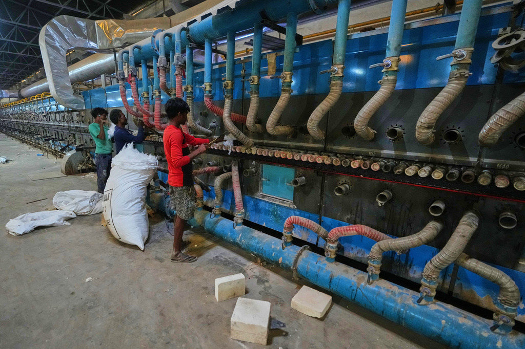 Workers perform maintenance on a machine at a shuttered ceramic factory in Morbi in the Indian state of Gujarat, Wednesday, April 8, 2026. (AP Photo/Ajit Solanki)
