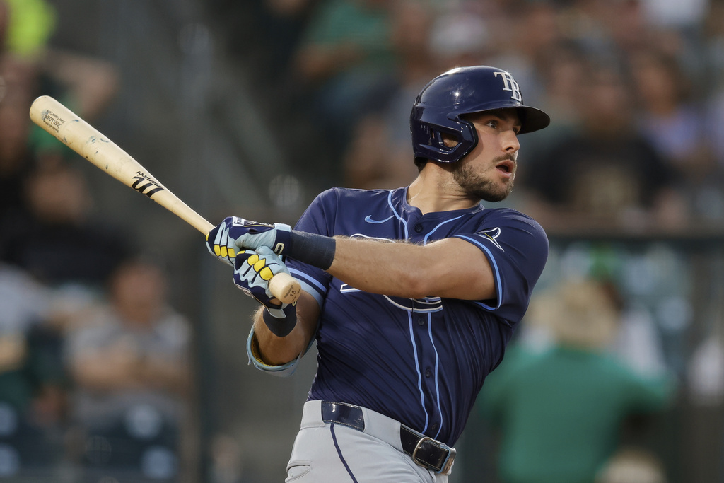 Tampa Bay Rays' Josh Lowe hits watches his sacrifice fly during the third inning of a baseball game against the Athletics, Monday, Aug. 11, 2025, in West Sacramento, Calif. (AP Photo/Sergio Estrada)